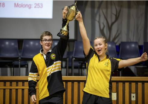 Harry Duguid and Emily Thomas holding up the Rural Cup trophy.